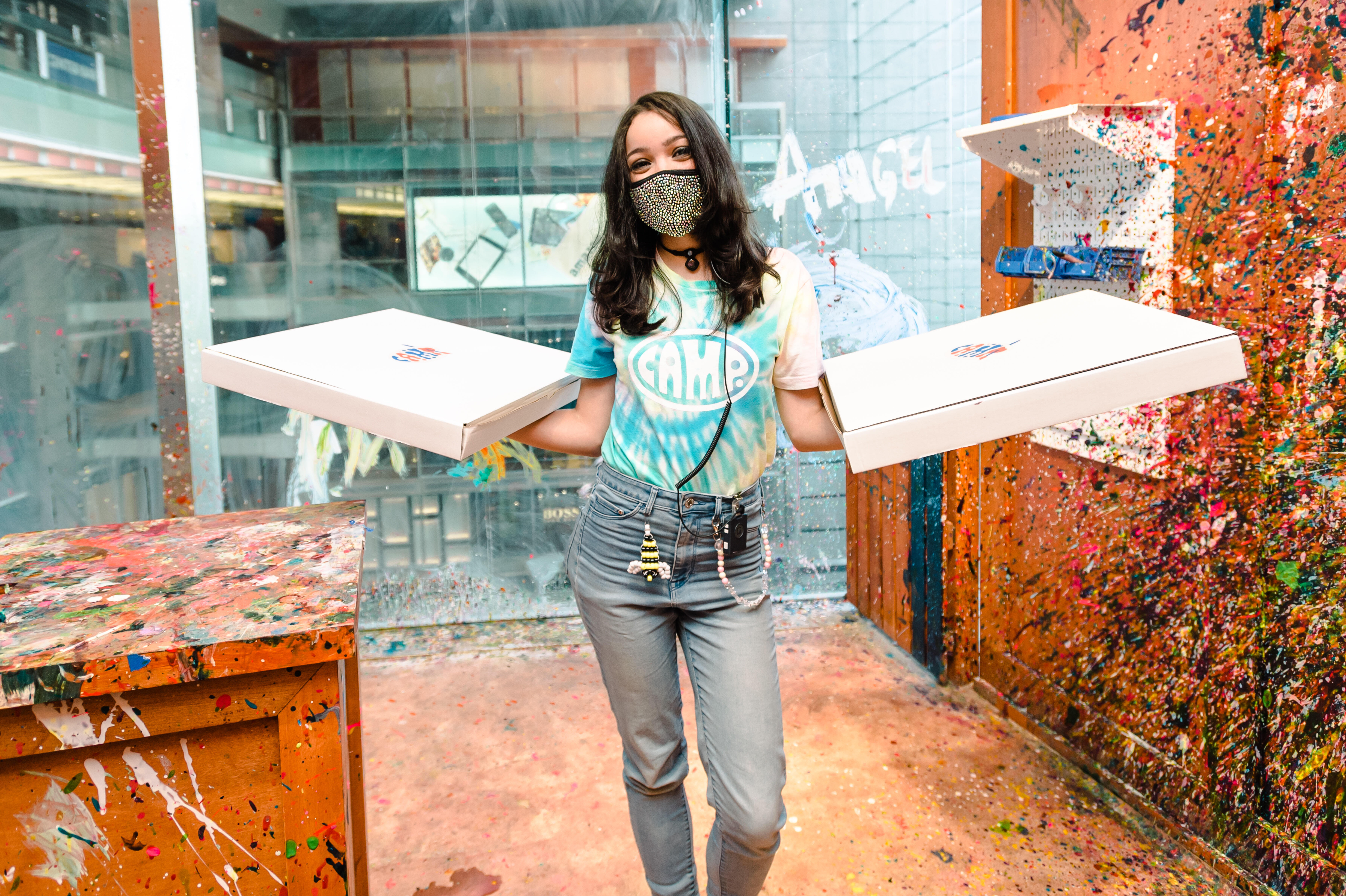 Staff member holding pizzas